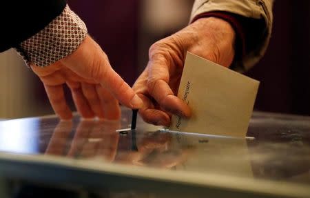 A voter casts his ballot at the polling station to vote in the first round of 2017 French presidential election in Paris, France, April 23, 2017. REUTERS/Christian Hartmann