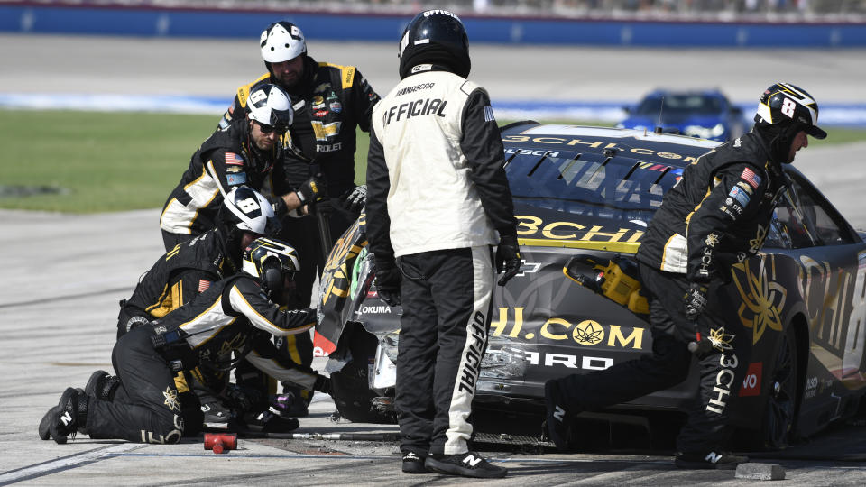 The pit crew works on Kyle Busch's car after he touched the wall during the NASCAR Cup Series auto race at Texas Motor Speedway in Fort Worth, Texas, Sunday, Sept 25, 2022. (AP Photo/Randy Holt)