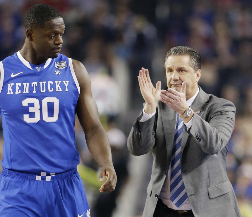 Kentucky head coach John Calipari cheers on players including forward Julius Randle (30) during the first half of the NCAA Final Four tournament college basketball semifinal game against Wisconsin Saturday, April 5, 2014, in Arlington, Texas. (AP Photo/Eric Gay)