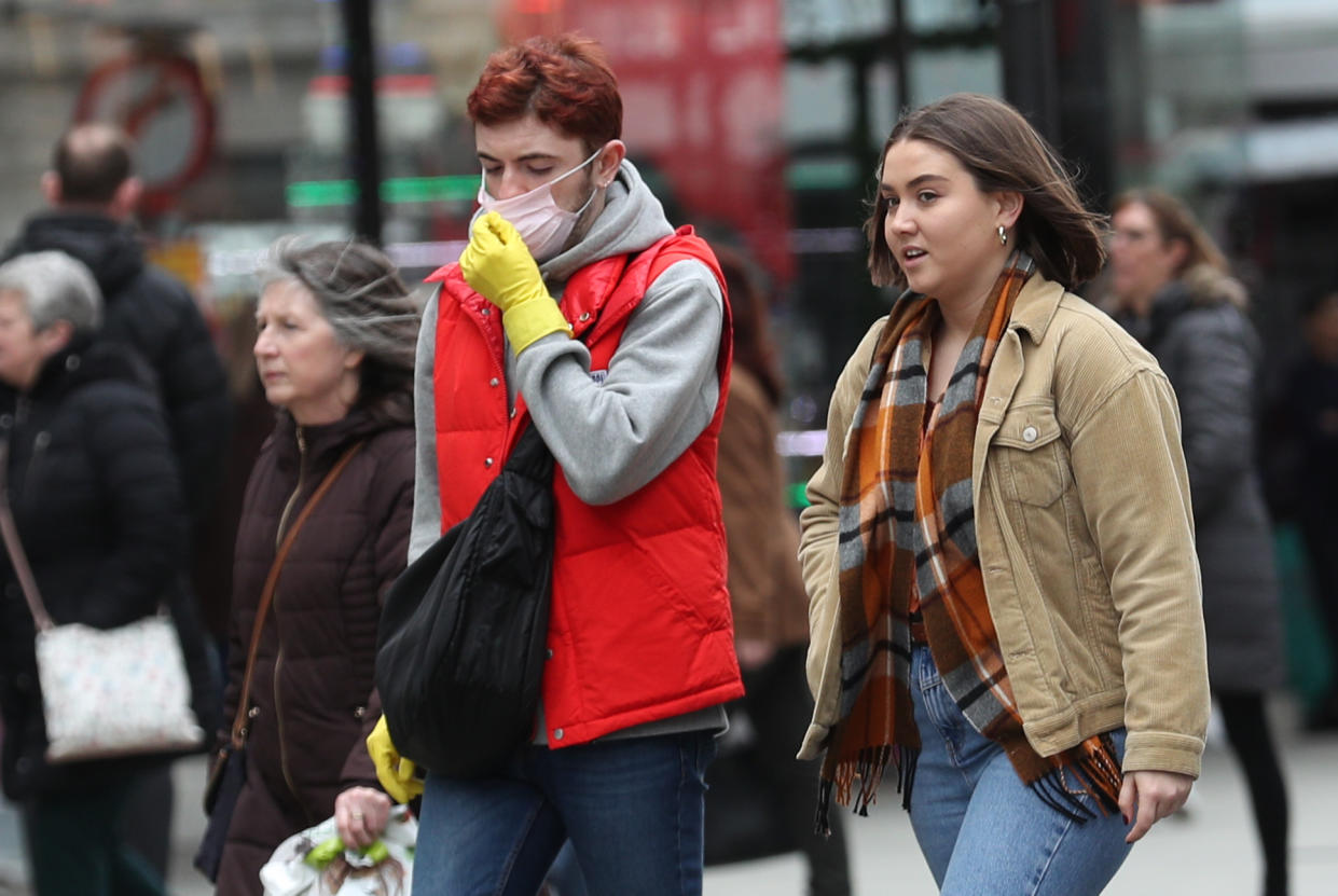 A man wearing a protective face mask walking down Oxford Street in London, as the Government's top scientist warned that up to 10,000 people in the UK are already infected. (Photo by Yui Mok/PA Images via Getty Images)