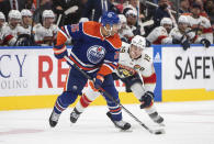 Florida Panthers' Matthew Tkachuk (19) chases Edmonton Oilers' Darnell Nurse (25) during the third period of an NHL hockey game in Edmonton, Alberta, Monday, Nov. 28, 2022. (Jason Franson/The Canadian Press via AP)