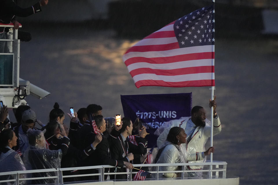 LeBron James and Team USA wave the American flag during Olympic opening ceremonies in Paris, France, on July 26, 2024. (Eric W. Rasco/Sports Illustrated via Getty Images)