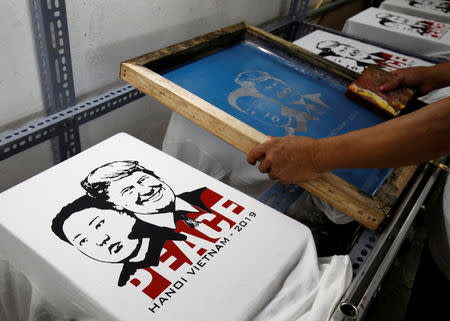 Vietnamese shop owner Truong Thanh Duc prints t-shirts for sale with images of U.S. President Donald Trump and North Korean leader Kim Jong Un ahead of USA-DPRK Summit in Hanoi, Vietnam February 21, 2019. REUTERS/Kham