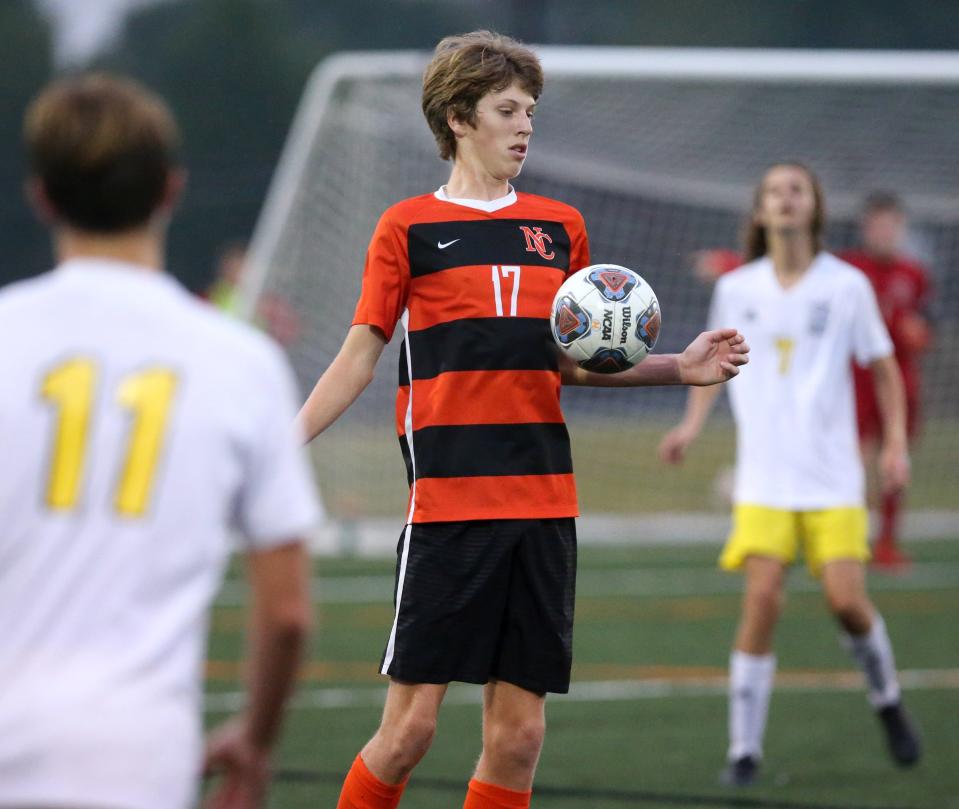 Alec McLeod, 17, of Hoover keeps the ball in front of him as  Steve Bossler, 11, of Perry moves in on the play during their game at Hoover on Tuesday, Sept. 21, 2021.