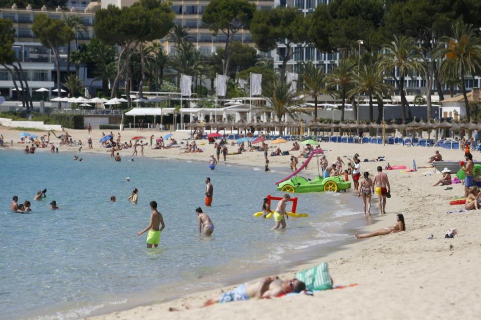 People enjoy themselves at Magaluf beach in Majorca (REUTERS)