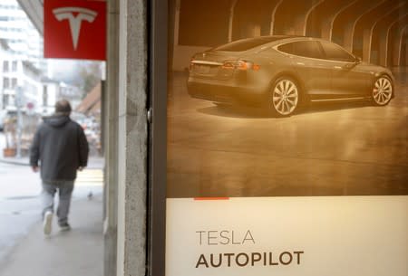 FILE PHOTO: Advertisement promotes Tesla Autopilot at a showroom of U.S. car manufacturer Tesla in Zurich