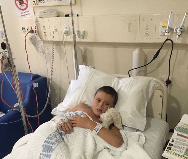 11-year-old Cooper Sullivan crawled into his parent's room on Sunday night after eating a chicken schnitzel roll. Photo: Damian Sullivan