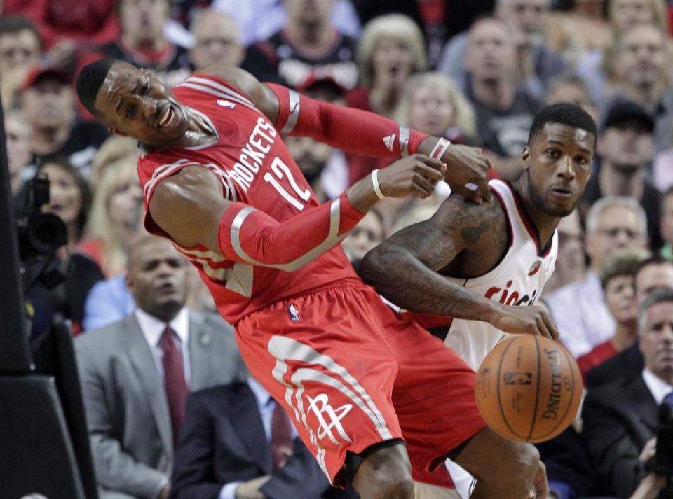 Houston Rockets center Dwight Howard, left, and Portland Trail Blazers forward Dorell Wright collide during the first half of Game 3 of an NBA basketball first-round playoff series in Portland, Ore., Friday, April 25, 2014. (AP Photo/Don Ryan)