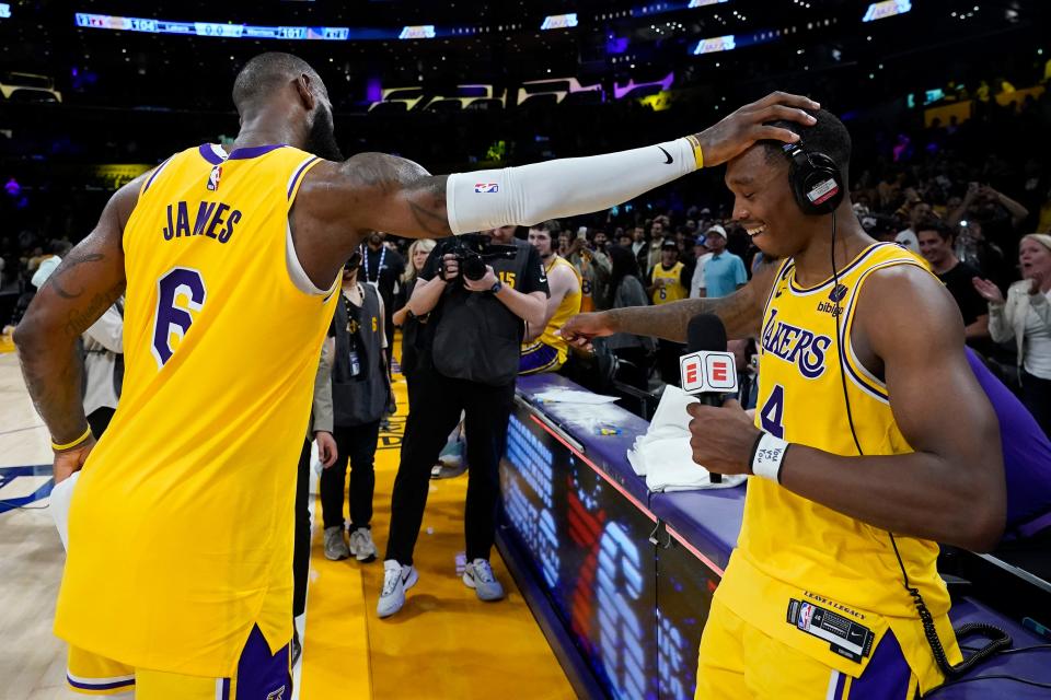 Los Angeles Lakers' LeBron James, left, congratulates Lonnie Walker IV after the Lakers defeated the Golden State Warriors 104-101 in Game 4 of the Western Conference semifinal.