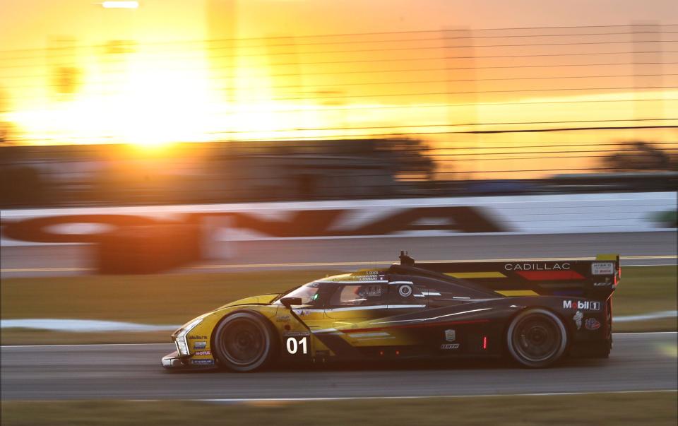 The no. 01 Cadillac V-LMDh runs through the chicane as the sun starts to brighten the sky , Sunday morning January 29, 2023 during the Rolex 24 at Daytona International Speedway.