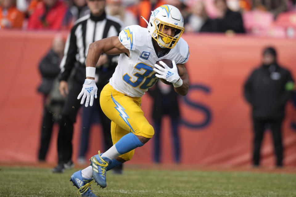 Los Angeles Chargers running back Austin Ekeler (30) runs against the Denver Broncos during the first half of an NFL football game, Sunday, Dec. 31, 2023, in Denver. (AP Photo/David Zalubowski)