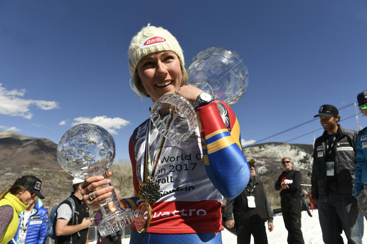 Mikaela Shiffrin holds the crystal globe trophy for the overall World Cup, right, and the smaller crystal globe for the World Cup slalom title, left, at the bottom of Aspen Mountain after the 2017 Audi FIS Ski World Cup Finals at Aspen Mountain on March 19, 2017 in Aspen, Colorado. (Photo by Helen H. Richardson/The Denver Post via Getty Images)