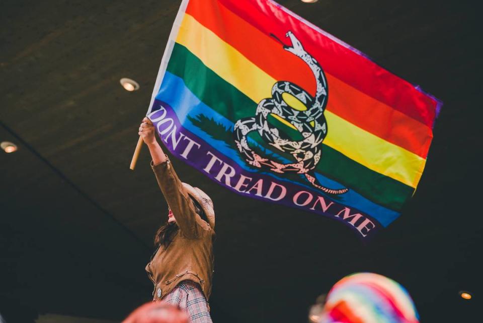 An attendee waves a flag at the 6th annual Pride in the Park celebration in Coeur d’Alene, Idaho, on June 11, 2022.