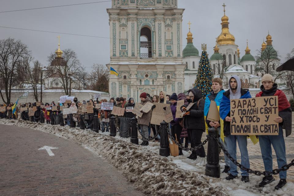 Relatives and friends of Ukrainian prisoners of war hold placards (AFP via Getty Images)