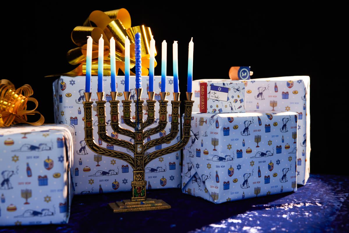 A menorah with gifts for Hanukkah.<p>Unsplash</p>