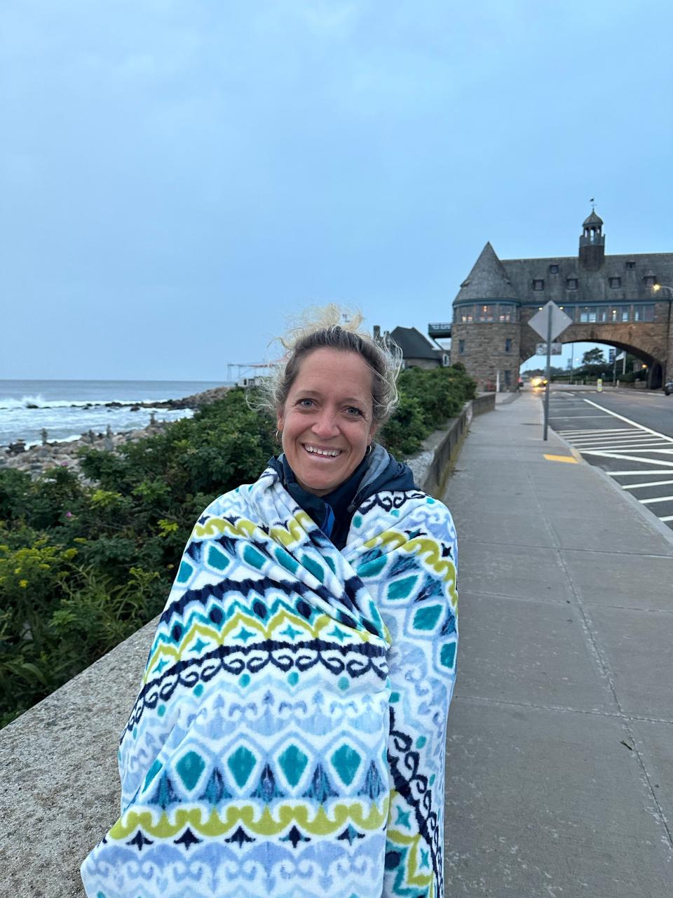 Beth Elam, of Marblehead, Massachusetts got up early at her aunt’s condo to take a sunrise walk across the green next to The Towers to view the ocean stirred up by Hurricane Lee.