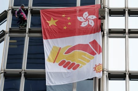 French urban climber Alain Robert climbs the Cheung Kong Center building in Hong Kong