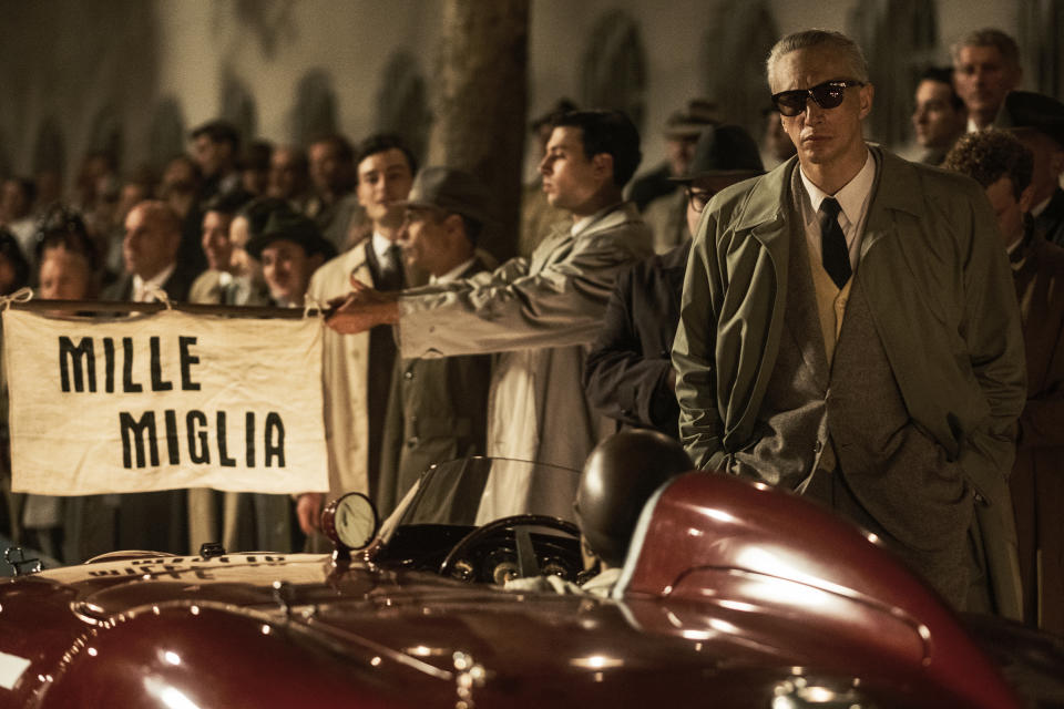 Long before sunrise, Enzo Ferrari (Adam Driver) stands at the starting line of the Mille Miglia in Brescia and gives pep talks to each of his drivers in "Ferrari." (Lorenzo Sisti)