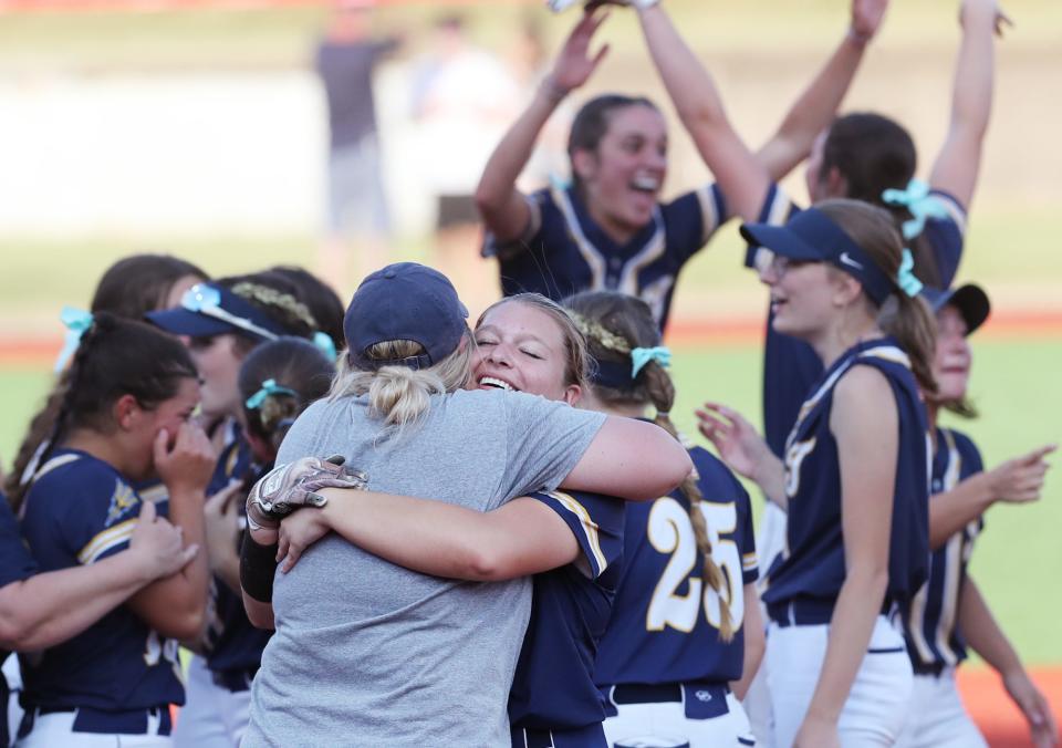 Talmadge head coach Brittany Lightel hugs Jocelyn Caffelle as they celebrate their victory over Greenville in the Div. II state semifinal softball at Firestone Stadium in Akron.