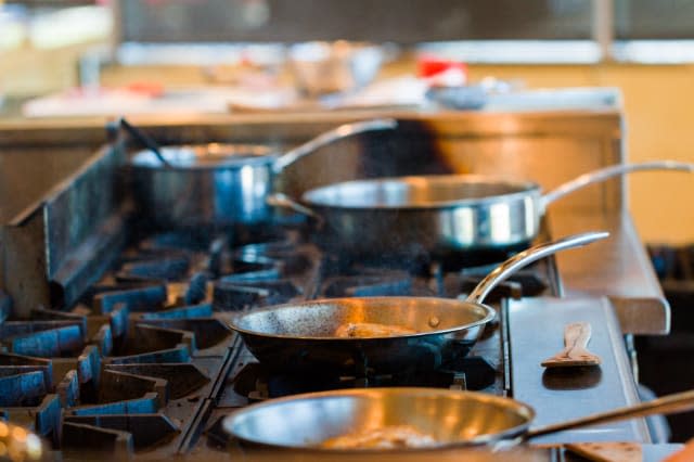 Kids learning how to cook in a cooking class.