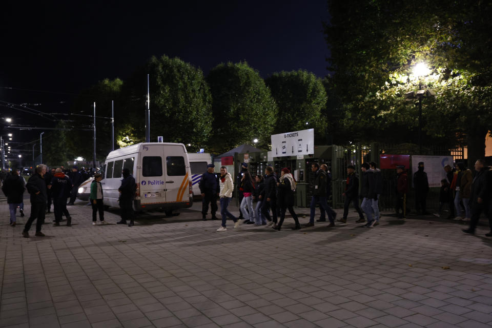 Supporters walk away from the venue after suspension of the Euro 2024 group F qualifying soccer match between Belgium and Sweden at the King Baudouin Stadium in Brussels, Monday, Oct. 16, 2023. The match was abandoned at halftime after two Swedes were killed in a shooting in central Brussels before kickoff. (AP Photo/Geert Vanden Wijngaert)