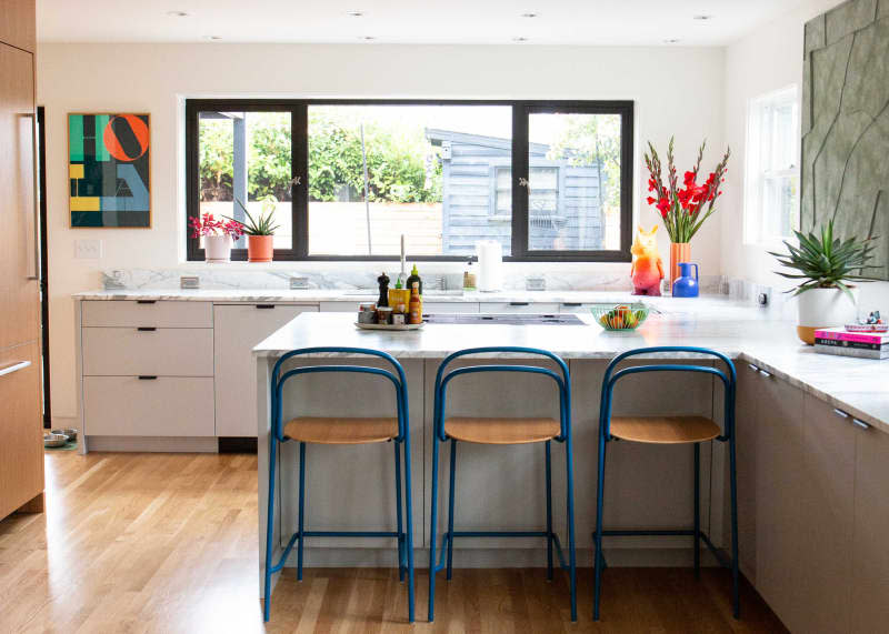 Blue stools under kitchen countertop.