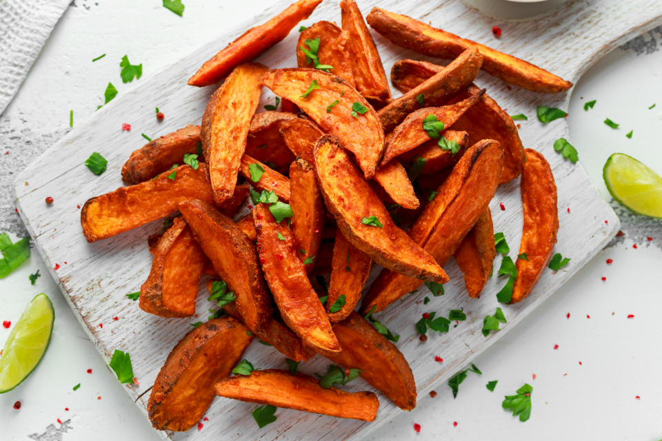 Healthy Homemade Baked Orange Sweet Potato Wedges with Crème fraiche sauce, herbs, salt and pepper