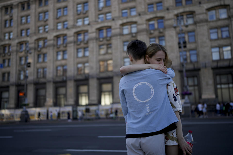 FILE - A couple embrace during Kyiv Day celebrations in Kyiv, Ukraine, Sunday, May 29, 2022. With war raging on fronts to the east and south, the summer of 2022 is proving bitter for the Ukrainian capital, Kyiv. The sun shines but sadness and grim determination reign. (AP Photo/Natacha Pisarenko, File)