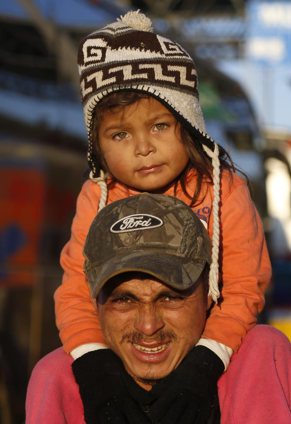 Central American migrants who are moving as a caravan toward the U.S. border start leaving Guadalajara, Mexico, early Tuesday, Nov. 13, 2018. While they previously suffered from the heat on their journey through Honduras, Guatemala and southern Mexico, they now trek along highways wrapped in blankets to fend off the morning chill. (AP Photo/Marco Ugarte)