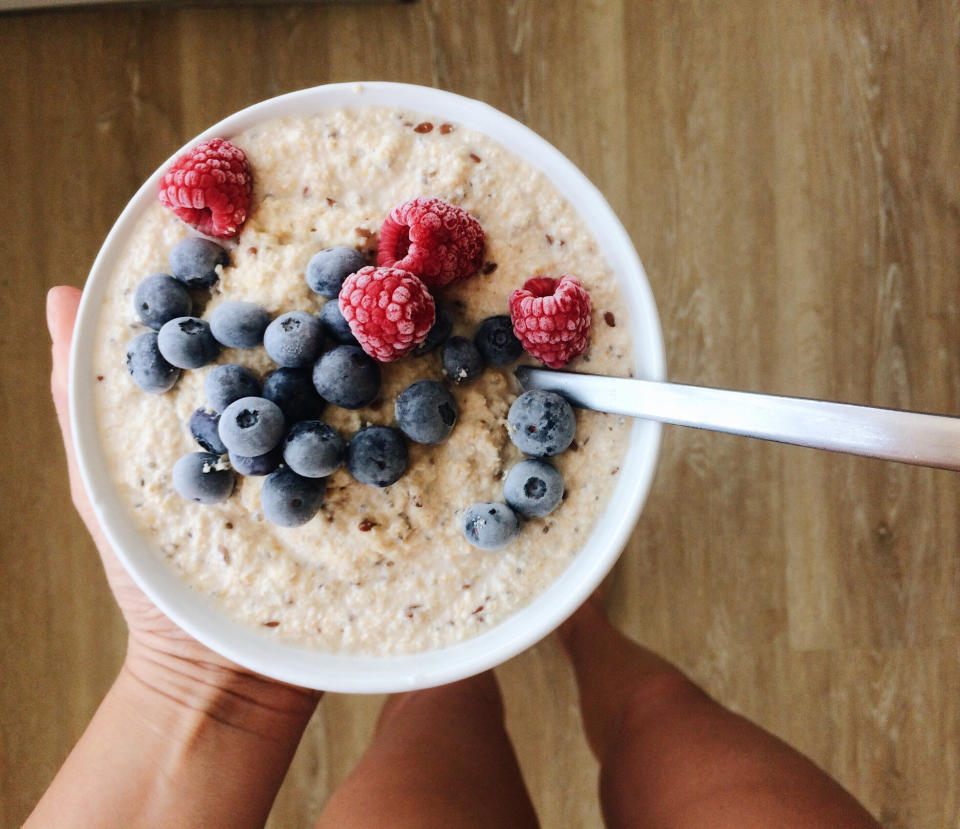 A bowl of oatmeal with berries.