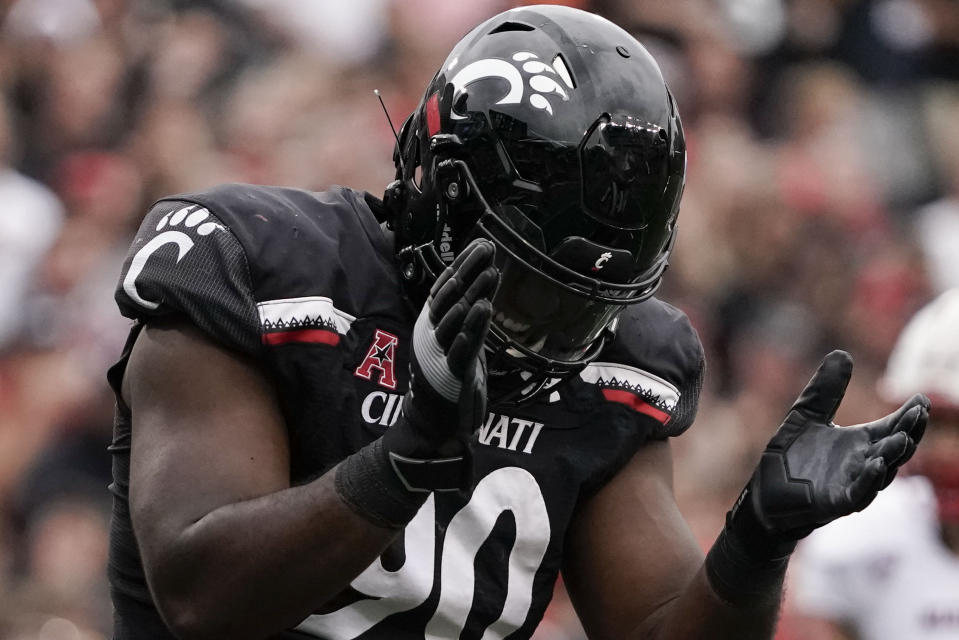 Cincinnati defensive lineman Jabari Taylor (90) reacts after sacking Miami (Ohio) quarterback AJ Mayer during the second half of an NCAA college football game Saturday, Sept. 4, 2021, in Cincinnati. (AP Photo/Jeff Dean)