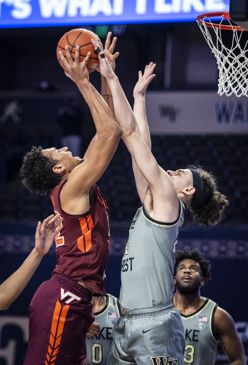 Virginia Tech forward Keve Aluma (22) shoots over defense from Wake Forest forward Ismael Massoud (25) during an NCAA college basketball game Sunday, Jan. 17, 2021, in Winston-Salem, N.C. (Andrew Dye/The Winston-Salem Journal via AP)