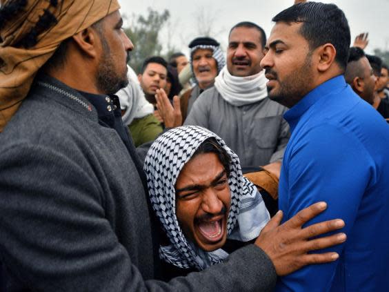 An Iraqi man mourns his brother at a funeral procession for anti-government demonstrators killed during protests in Najaf (Getty)