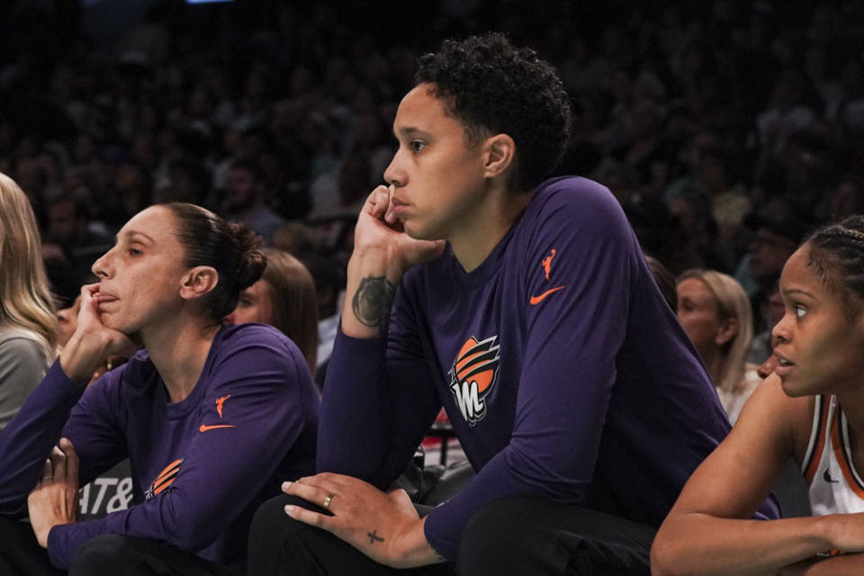 Phoenix Mercury center Brittney Griner, center, and teammate Diana Taurasi, left, watch from the bench, during first quarter of WNBA basketball game against New York Liberty, Sunday, June 18, 2023, in New York. (AP Photo/Bebeto Matthews)