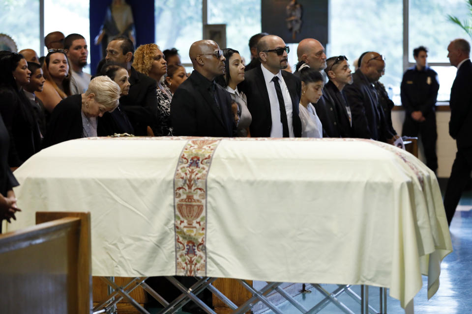 Family members stand during the funeral of Evelyn Rodriguez at Saint Anne's Roman Catholic Church, in Brentwood, N.Y., Friday, Sept. 21, 2018. Rodriguez, 50, is a mother recognized by President Donald Trump for turning grief over her daughter's suspected gang killing into a crusade against MS-13. She was struck and killed by an SUV on Sept. 14 after a heated confrontation with the driver over the placement of a memorial to her slain daughter, Kayla Cuevas. (AP Photo/Richard Drew)