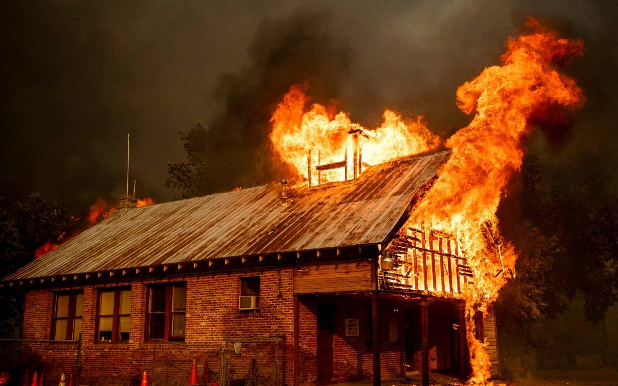 A schoolhouse burns as the Carr Fire tears through California where 38,000 people have been ordered to flee  - FR34727 AP