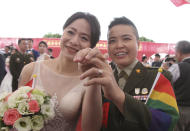 Lesbian couple Yi Wang, right, and Yumi Meng show their wedding rings during a military mass weddings ceremony in Taoyuan city, northern Taiwan, Friday, Oct. 30, 2020. Two lesbian couples tied the knot in a mass ceremony held by Taiwan's military on Friday in a historic step for the island. Taiwan is the only place in Asia to have legalized gay marriage, passing legislation in this regard in May 2019. (AP Photo/Chiang Ying-ying)