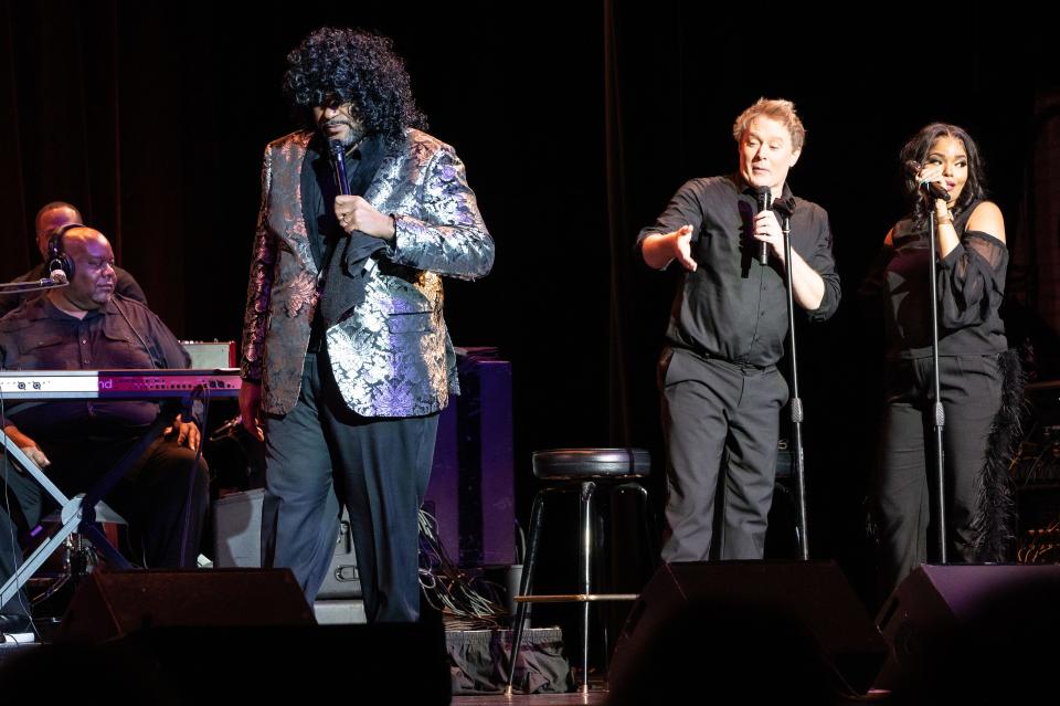 Ruben Studdard (left) dons a curly wig while performing with Clay Aiken at the Midland Theatre on May 2, 2023.