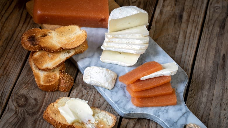 quince paste slices with cheese on board