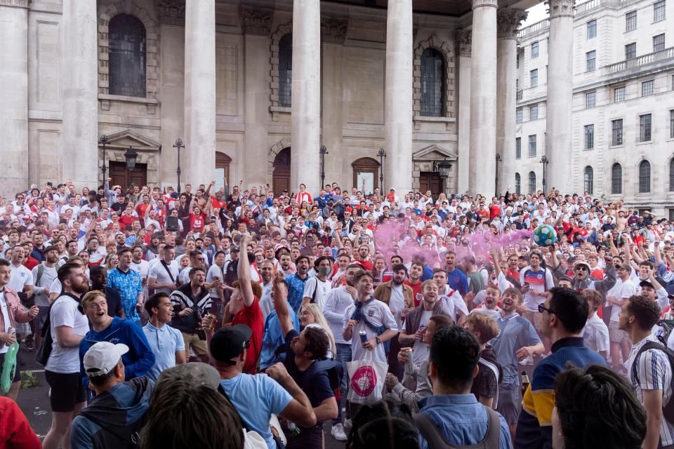 A large group of England soccer or football fans congregate outside to watch England in the Euro Cup finals.