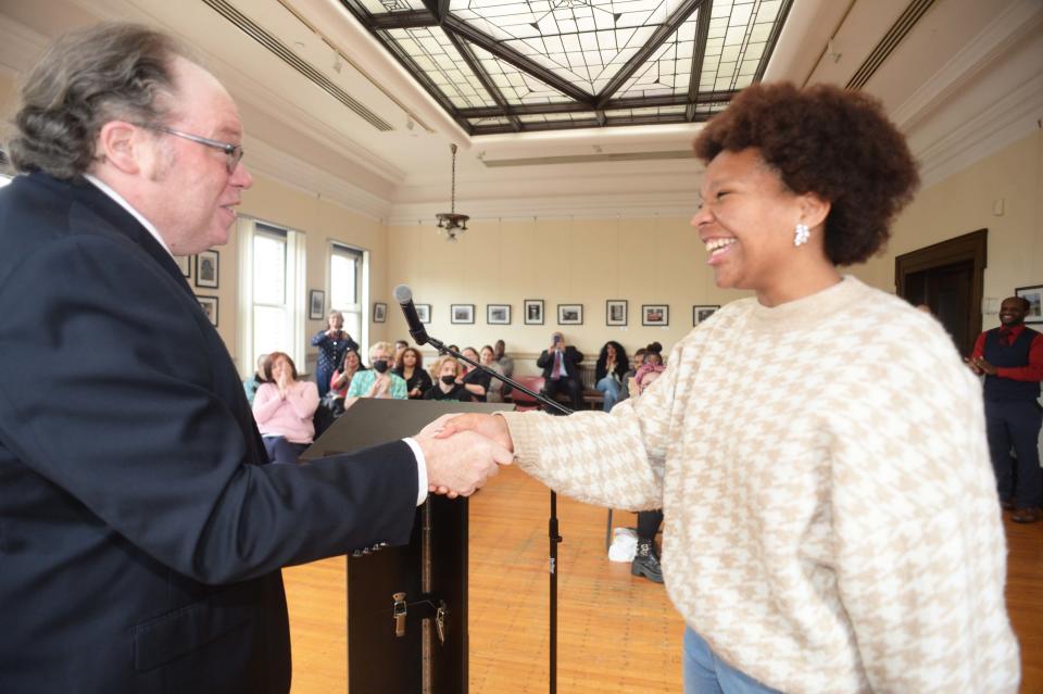 Head judge Mark Walsh introduces  Brockton's First Youth Poet Laureate Ayanna Blake at the public library on Saturday, May 7, 2022.