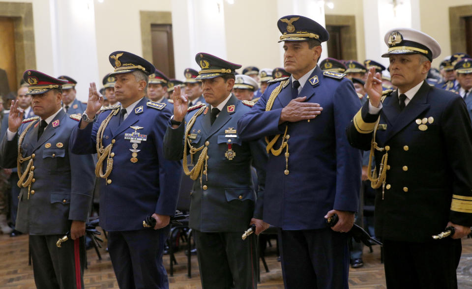 Bolivia's new Commander in Chief of the Armed Forces, Gen. Carlos Sergio Orellana Centellas, from left, Chief of Staff of the Command, Gen. Pablo Guerra Camacho, General Commander of the Army, Gen. Ivan Inchauste Rioja, Commander of the Bolivian Air Force Commander Ciro Orlando Alvarez and General Commander of the Navy, Orlando Mejia Heredia, right, take their oath of office from the opposition senator who has claimed Bolivia's presidency Jeanine Anez, during a swearing-in ceremony at the government palace in La Paz, Bolivia, Wednesday, Nov. 13, 2019. Anes faces the challenge of stabilizing the nation and organizing national elections within three months at a time of political disputes that pushed former President Evo Morales to fly off to self-exile in Mexico after 14 years in power. (AP Photo/Juan Karita)