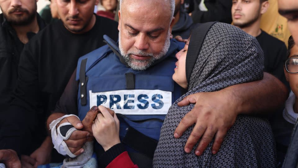 Al Jazeera's Gaza bureau chief Wael Al-Dahdouh (center) hugs his daughter during the funeral of his son, Hamza Al-Dahdouh, a reporter who was killed in an Israeli strike in southern Gaza, on January 7. - AFP/Getty Images