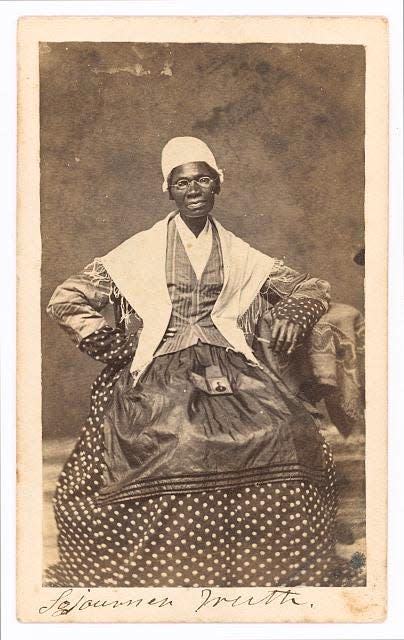 Sojourner Truth seated with photograph of her grandson, James Caldwell of Co. H, 54th Massachusetts Infantry Regiment, on her lap.