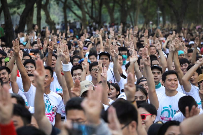 Runners flash three finger salute as they attend at "Run Against Dictatorship" event at a Public park in Bangkok