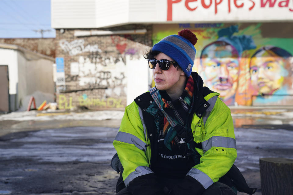 Madi Ramirez-Tentinger, a lead organizer for activism, waits to be interviewed on Feb. 24, 2021, at George Floyd Square in Minneapolis. Ten months after police officers brushed off George Floyd's moans for help on the street outside a south Minneapolis grocery, the square remains a makeshift memorial for Floyd who died at the hand of police making an arrest. The trial of former Minneapolis police officer Derek Chauvin, one of the four officers, will begin with jury selection on March 8. (AP Photo/Jim Mone)