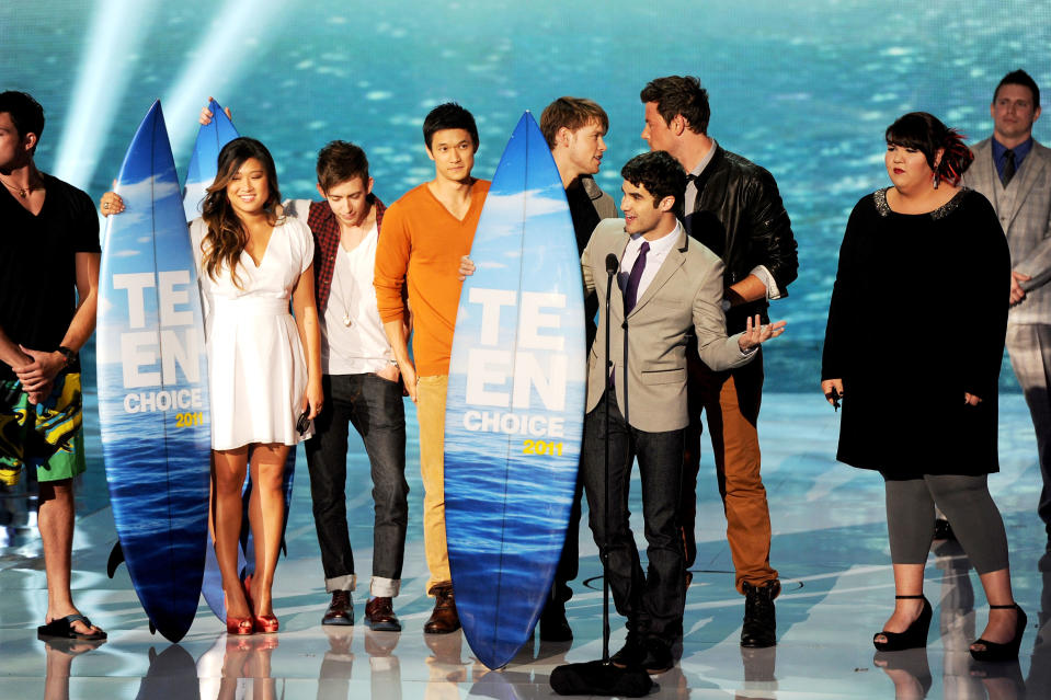 UNIVERSAL CITY, CA - AUGUST 07: (L-R) Actors Jenna Ushkowitz, Kevin McHale, Harry Shum Jr., Chord Overstreet, Cory Monteith, Darren Criss, Ashley Fink accept the Choice Comedy award onstage during the 2011 Teen Choice Awards held at the Gibson Amphitheatre on August 7, 2011 in Universal City, California. (Photo by Kevin Winter/Getty Images)