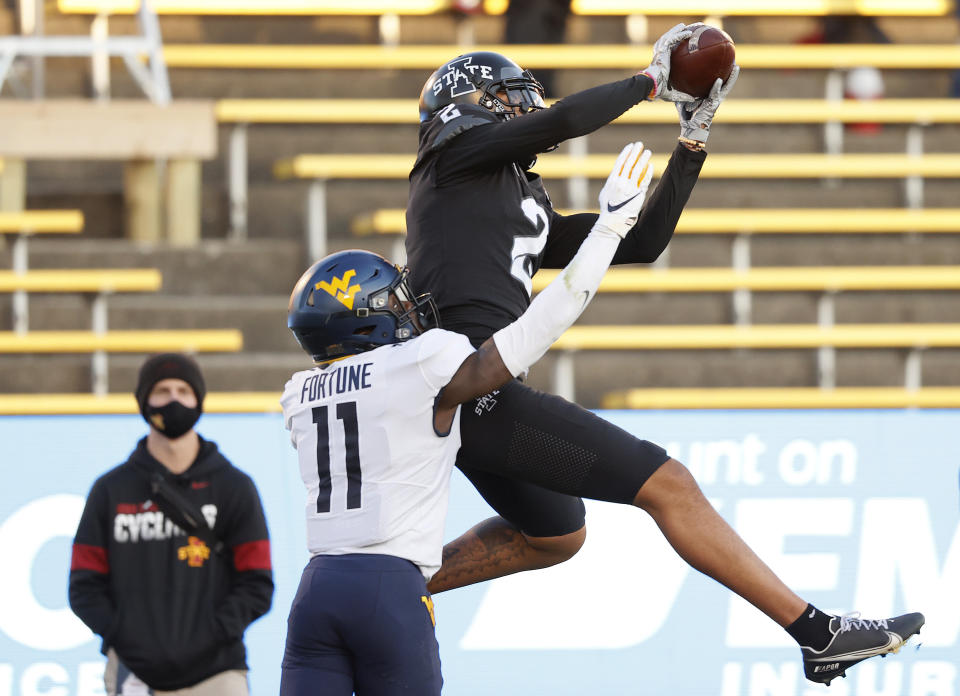 Iowa State wide receiver Sean Shaw, right, leaps for a catch as West Virginia cornerback Nicktroy Fortune, left, tries to defend during the first half of an NCAA college football game, Saturday, Dec. 5, 2020, in Ames, Iowa. (AP Photo/Matthew Putney)