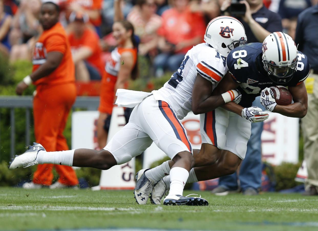 Auburn receiver Myron Burton Jr. (84) scores against Auburn Stephen Roberts (14) during their spring game. (AP Photo/Brynn Anderson)