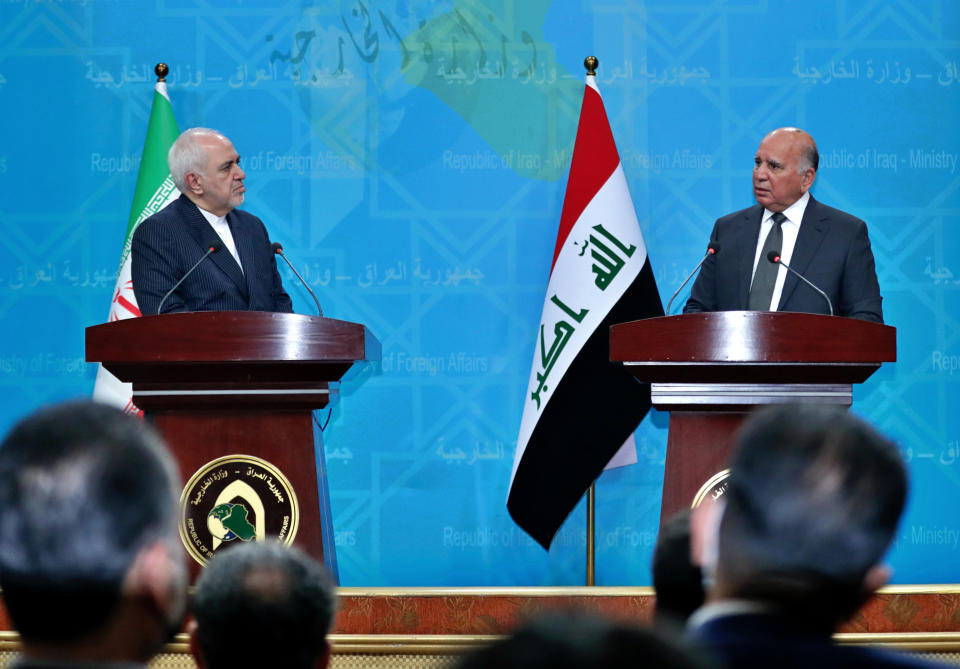 Iraqi Foreign Minister Fouad Hussein, right, and visiting Iranian Foreign Minister Mohammad Javad Zarif hold a news conference following their meeting in Baghdad, Iraq, Monday, April 26, 2021. (AP Photo/Khalid Mohammed)